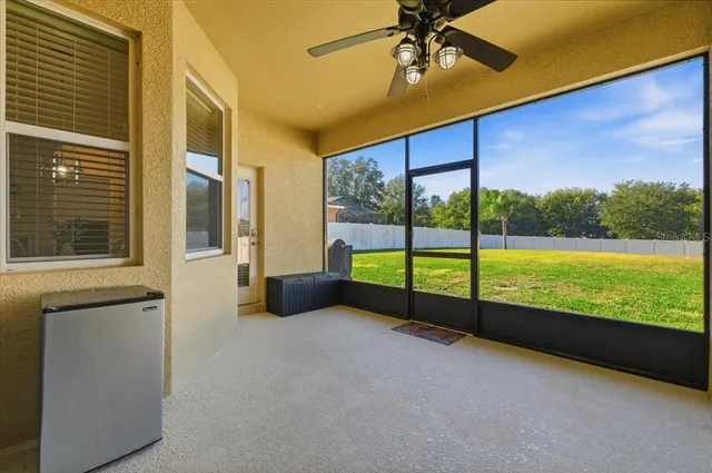 a view of a large pool with an outdoor space and seating area
