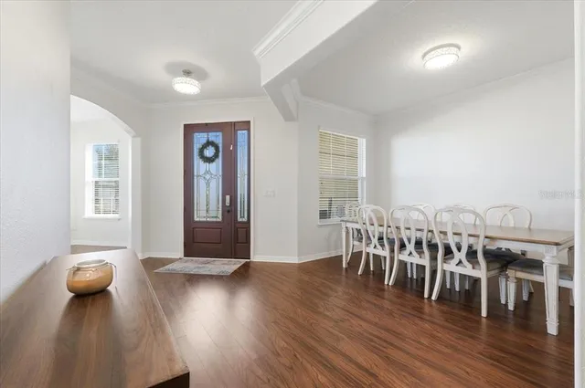 a view of a dining room with furniture and wooden floor