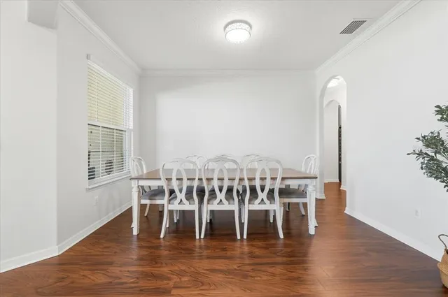 a view of a dining room with furniture wooden floor and windows