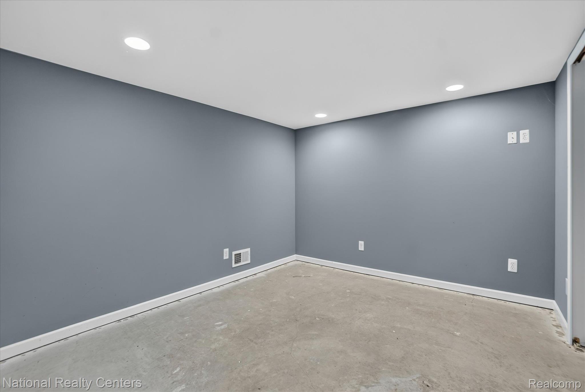 8280 West Rolston Road Linden, MI 48451 - Photo 22 of 47 Spacious room with painted walls, recessed lighting, concrete flooring, and white baseboards