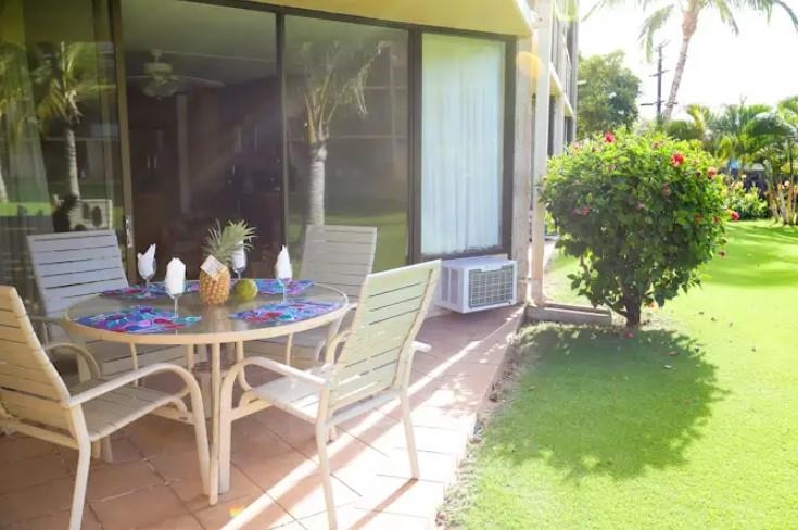 1032 South Kihei Road, Unit A103 Kihei, HI 96753 - Photo 23 of 48 a view of an outdoor dining space with a table and chairs