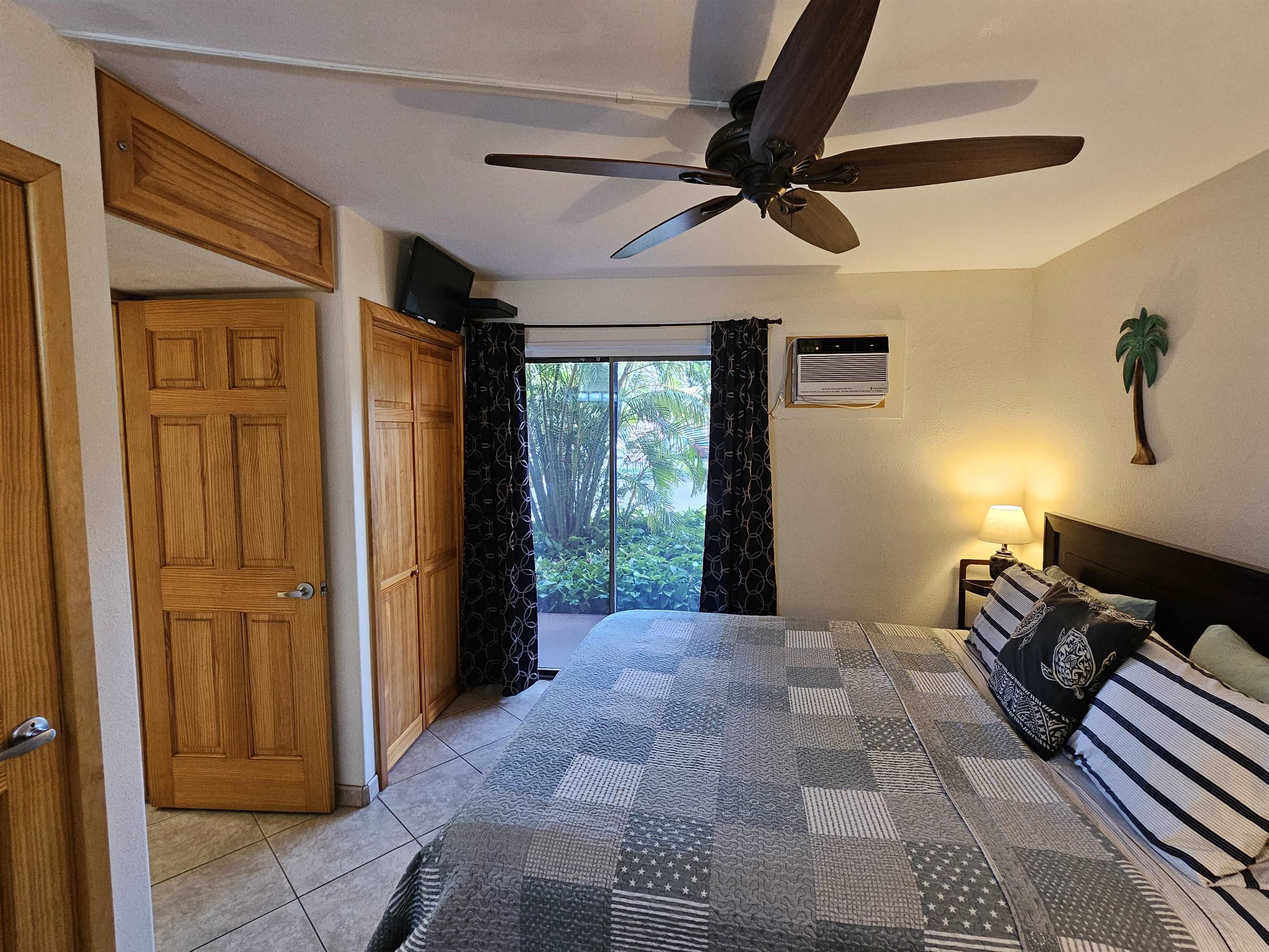 1032 South Kihei Road, Unit A103 Kihei, HI 96753 - Photo 29 of 48 a bed room with a bed and a window