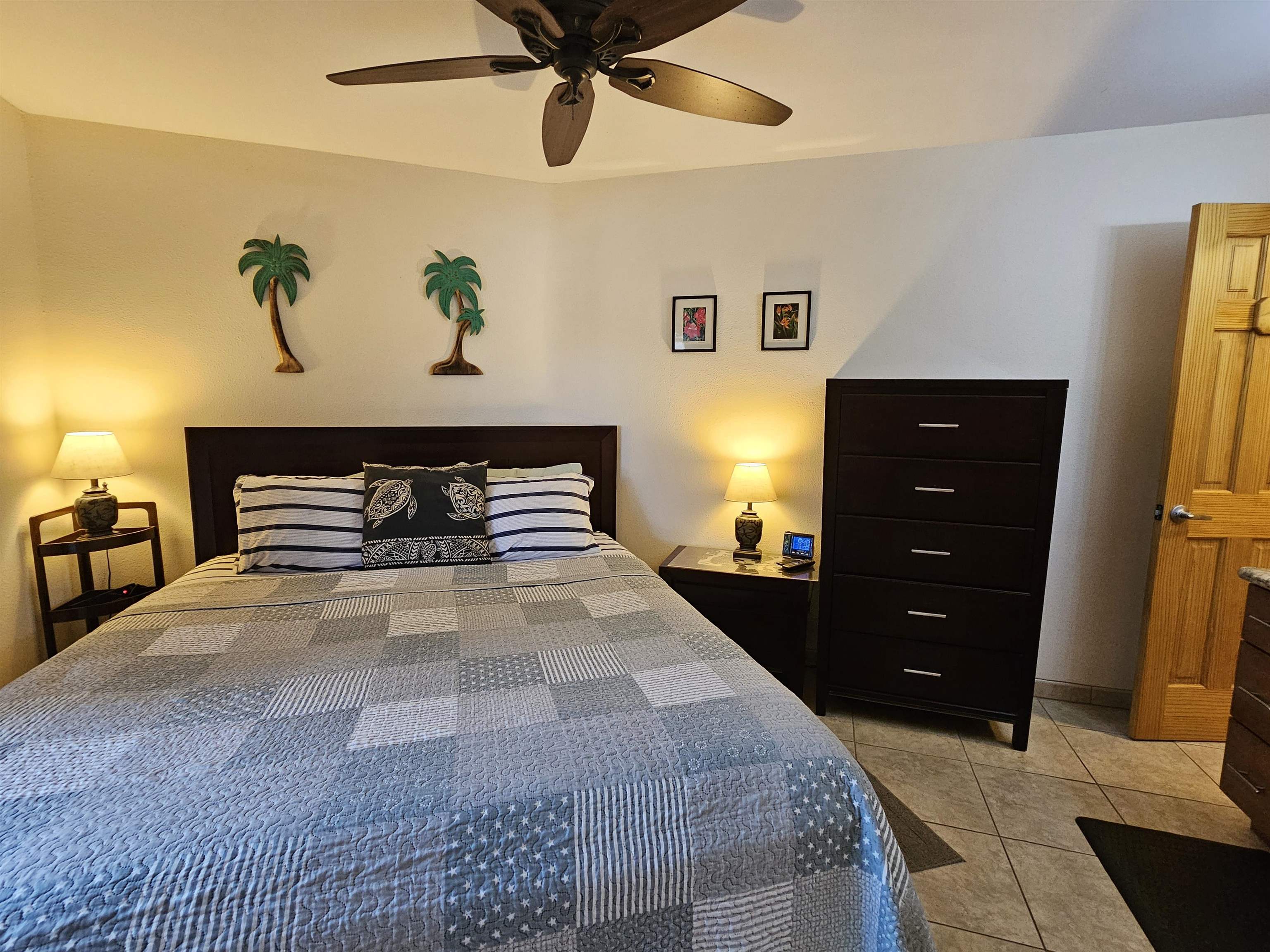 1032 South Kihei Road, Unit A103 Kihei, HI 96753 - Photo 30 of 48 a bedroom with a bed and a chandelier