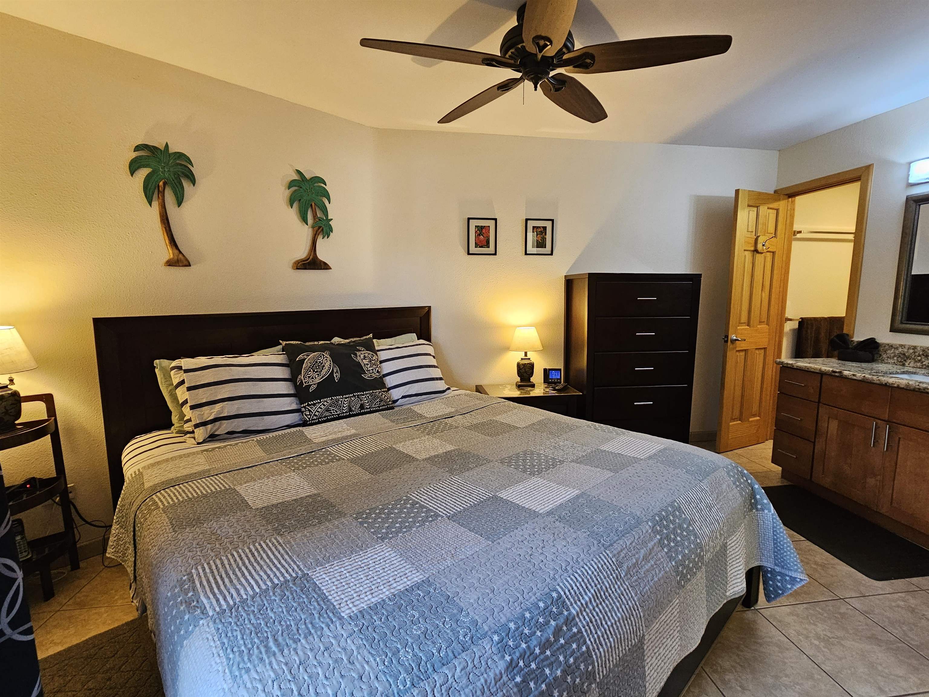 1032 South Kihei Road, Unit A103 Kihei, HI 96753 - Photo 32 of 48 a bedroom with a bed and wooden floor