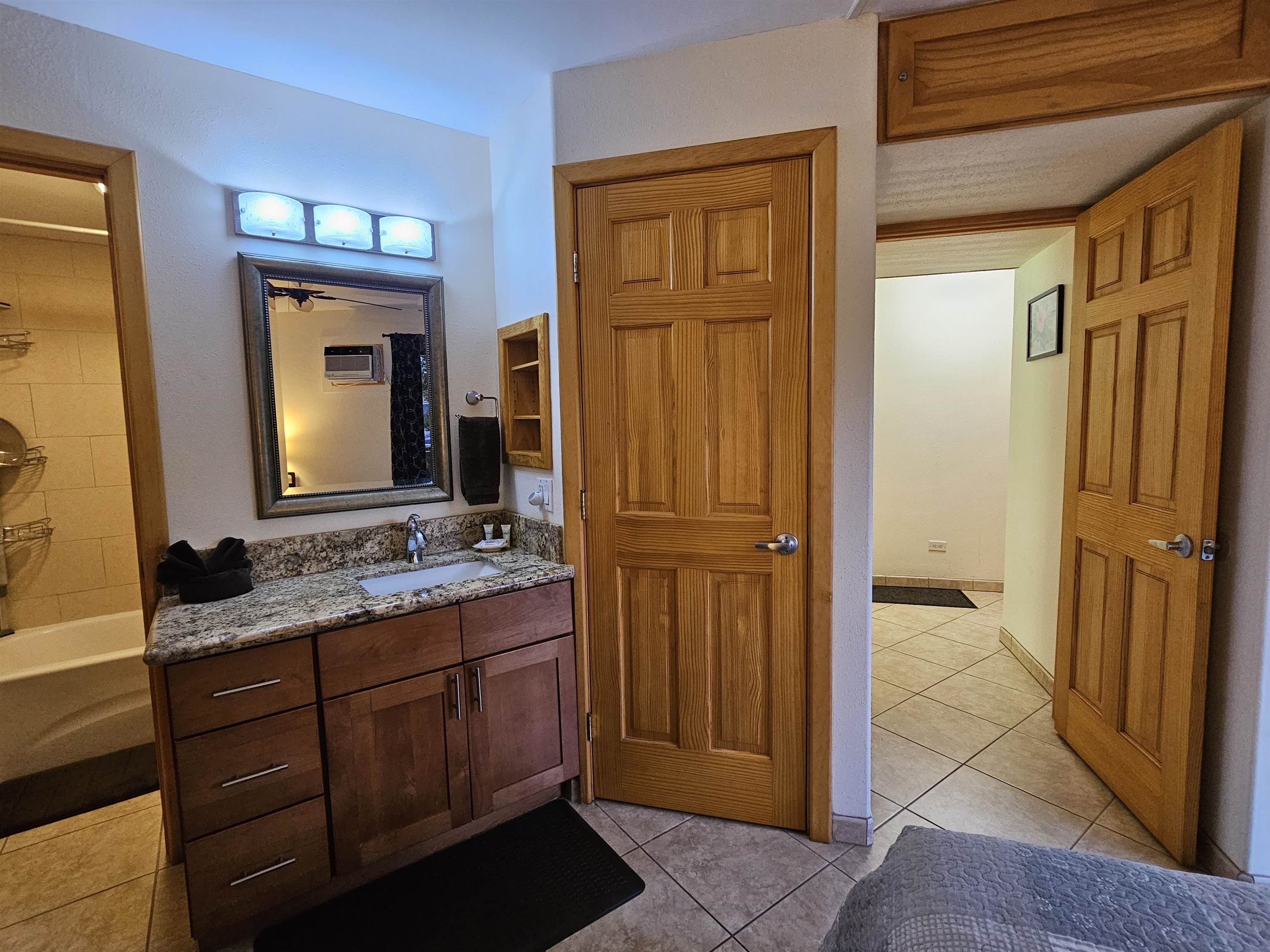 1032 South Kihei Road, Unit A103 Kihei, HI 96753 - Photo 34 of 48 a bathroom with a granite countertop sink and a mirror