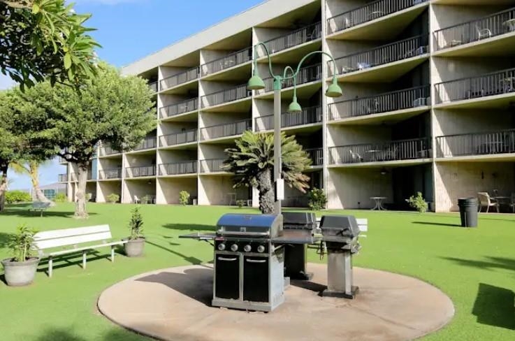1032 South Kihei Road, Unit A103 Kihei, HI 96753 - Photo 44 of 48 a front view of a house with a yard table and chairs
