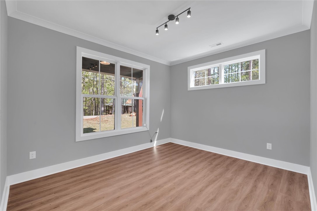 407 Blue Ridge Court Westminster, SC 29693 - Photo 7 of 48 This bright room features durable laminate flooring and inviting views through large windows.