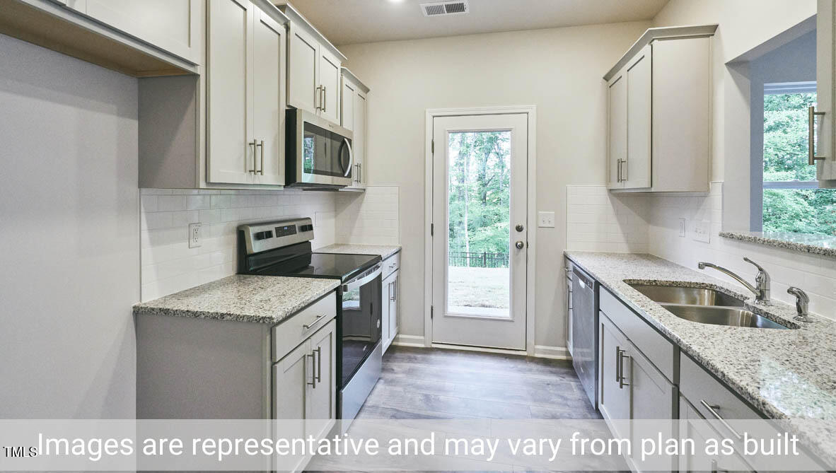 5344 Henley Ridge Drive, Unit 228 Graham, NC 27253 - Photo 12 of 30 a kitchen that has a sink and a stove