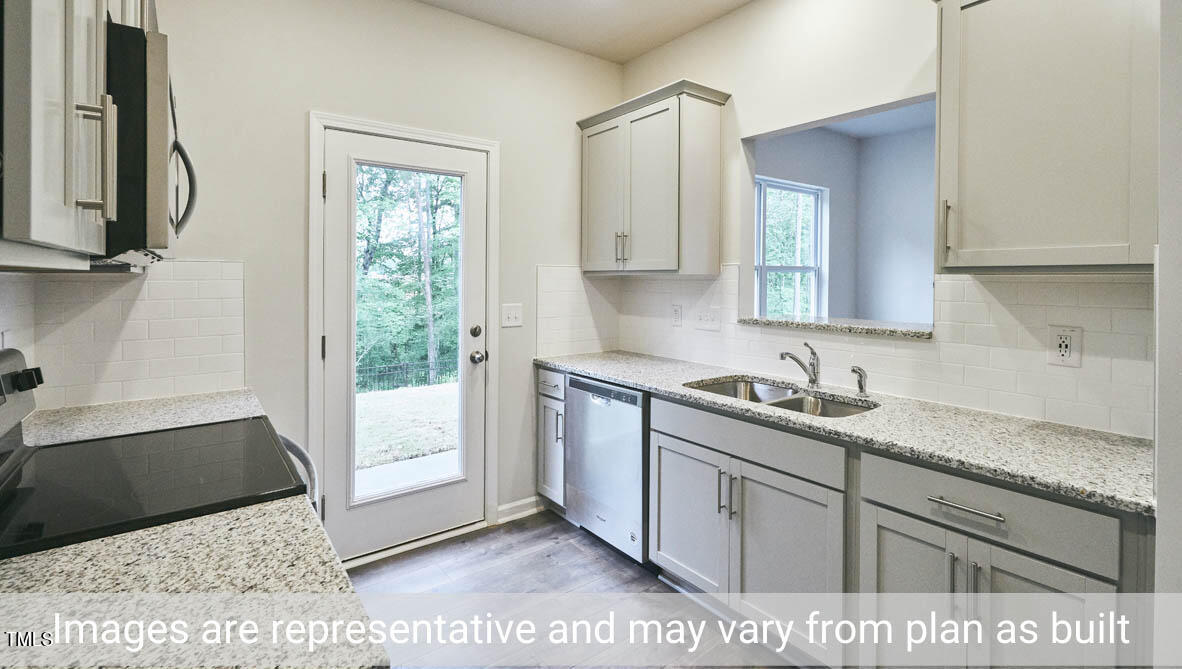 5344 Henley Ridge Drive, Unit 228 Graham, NC 27253 - Photo 13 of 30 a kitchen with a sink cabinets and a window
