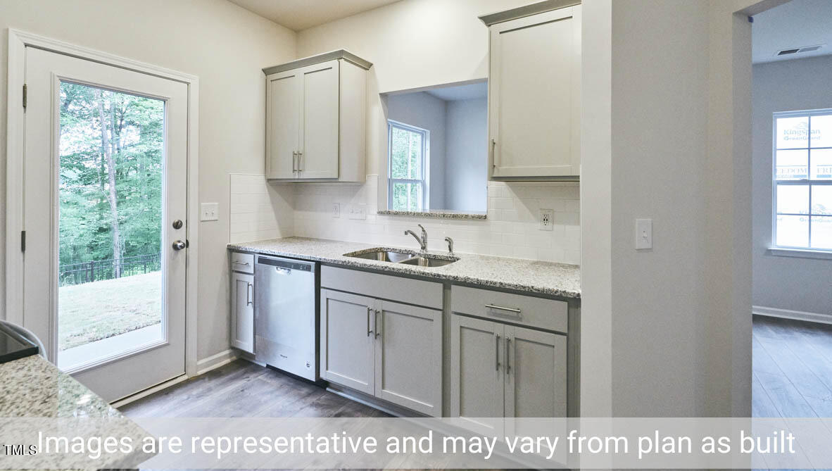 5344 Henley Ridge Drive, Unit 228 Graham, NC 27253 - Photo 14 of 30 a kitchen with a sink cabinets and a window