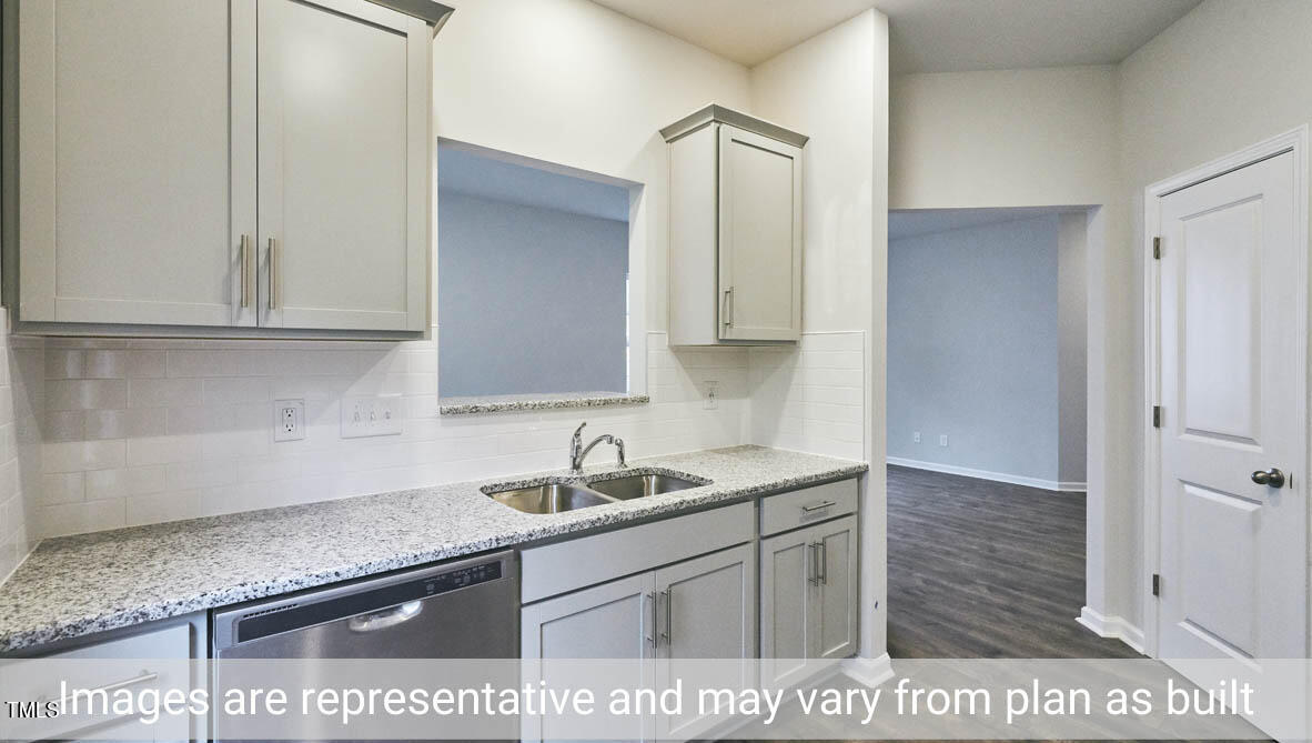 5344 Henley Ridge Drive, Unit 228 Graham, NC 27253 - Photo 15 of 30 a kitchen with stainless steel appliances granite countertop a sink and a white cabinets