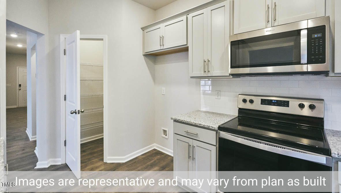 5344 Henley Ridge Drive, Unit 228 Graham, NC 27253 - Photo 17 of 30 a kitchen with stainless steel appliances and cabinets