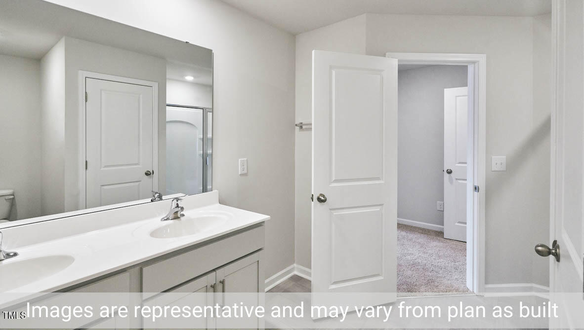 5344 Henley Ridge Drive, Unit 228 Graham, NC 27253 - Photo 21 of 30 a bathroom with a sink a mirror and a shower