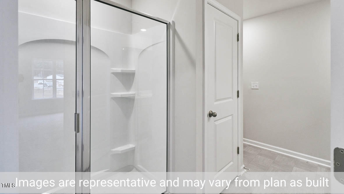 5344 Henley Ridge Drive, Unit 228 Graham, NC 27253 - Photo 24 of 30 a bathroom with a shower and a glass door