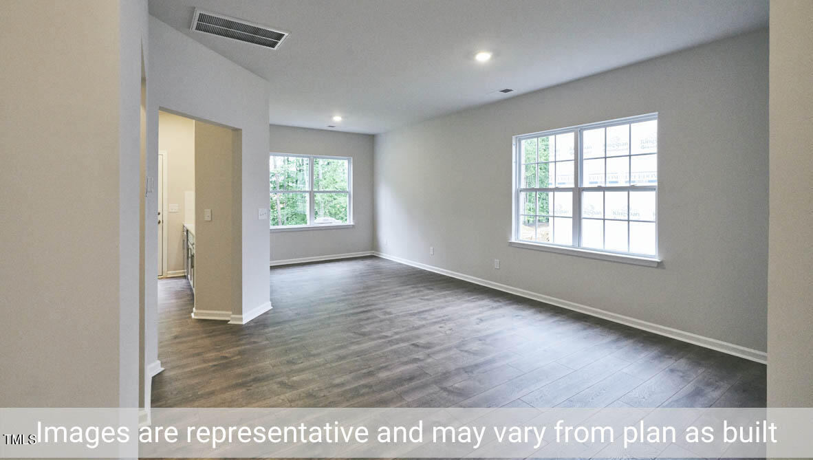 5344 Henley Ridge Drive, Unit 228 Graham, NC 27253 - Photo 4 of 30 an empty room with wooden floor and windows