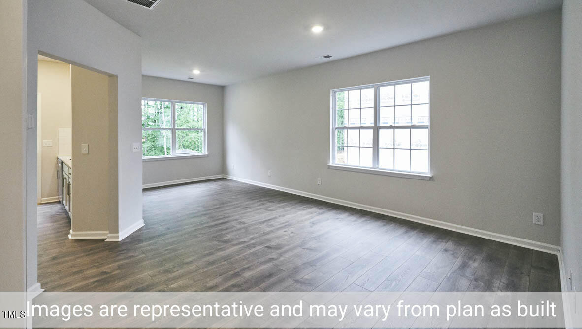 5344 Henley Ridge Drive, Unit 228 Graham, NC 27253 - Photo 5 of 30 an empty room with wooden floor and windows