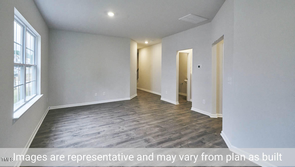 5344 Henley Ridge Drive, Unit 228 Graham, NC 27253 - Photo 8 of 30 a view of an empty room with wooden floor and a window