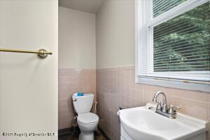 802 Madison Avenue Scranton, PA 18510 - Photo 21 of 52 a bathroom with a toilet sink and mirror