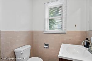 802 Madison Avenue Scranton, PA 18510 - Photo 27 of 52 a bathroom with a sink a toilet and a window