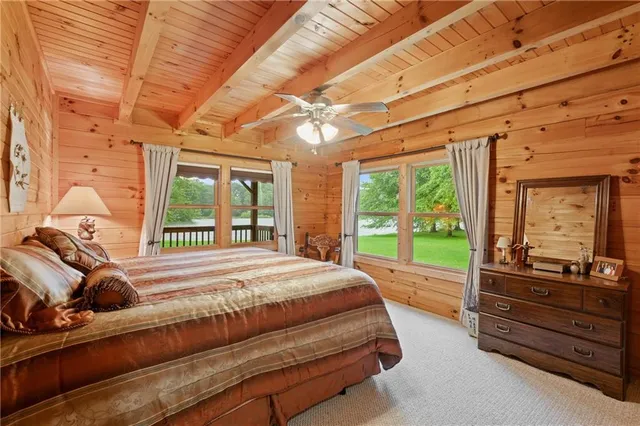 a bed sitting in a bedroom next to a window