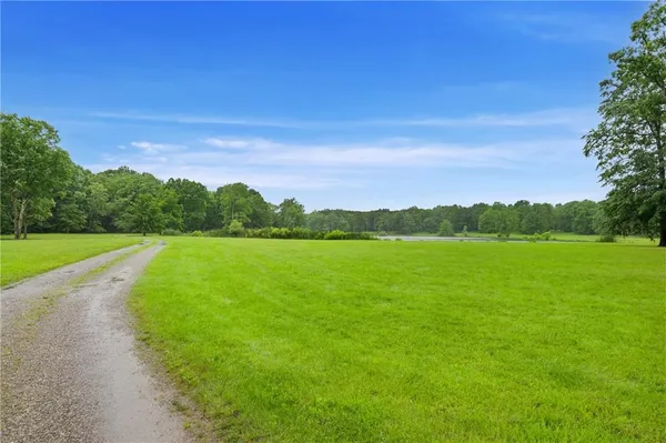 a view of a house with a backyard
