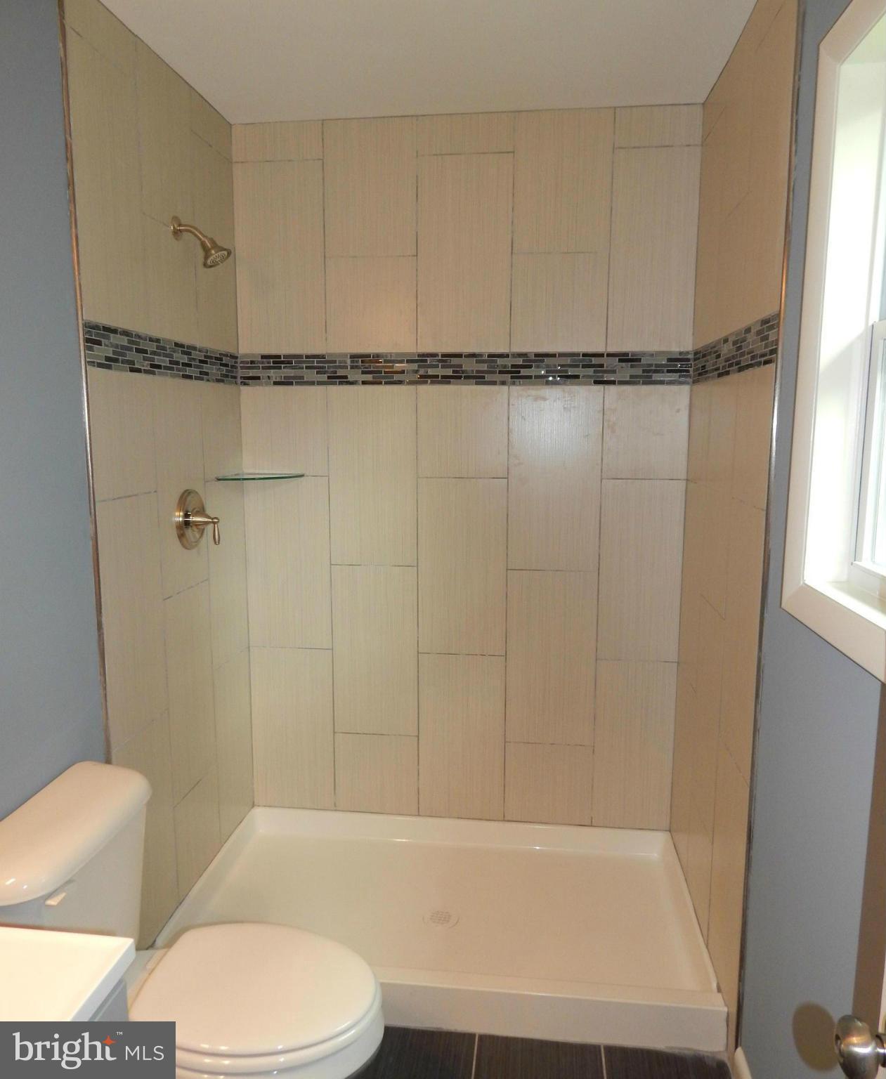 111 Calvert Towne Road Prince Frederick, MD 20678 - Photo 14 of 26 a bathroom with a shower and a toilet