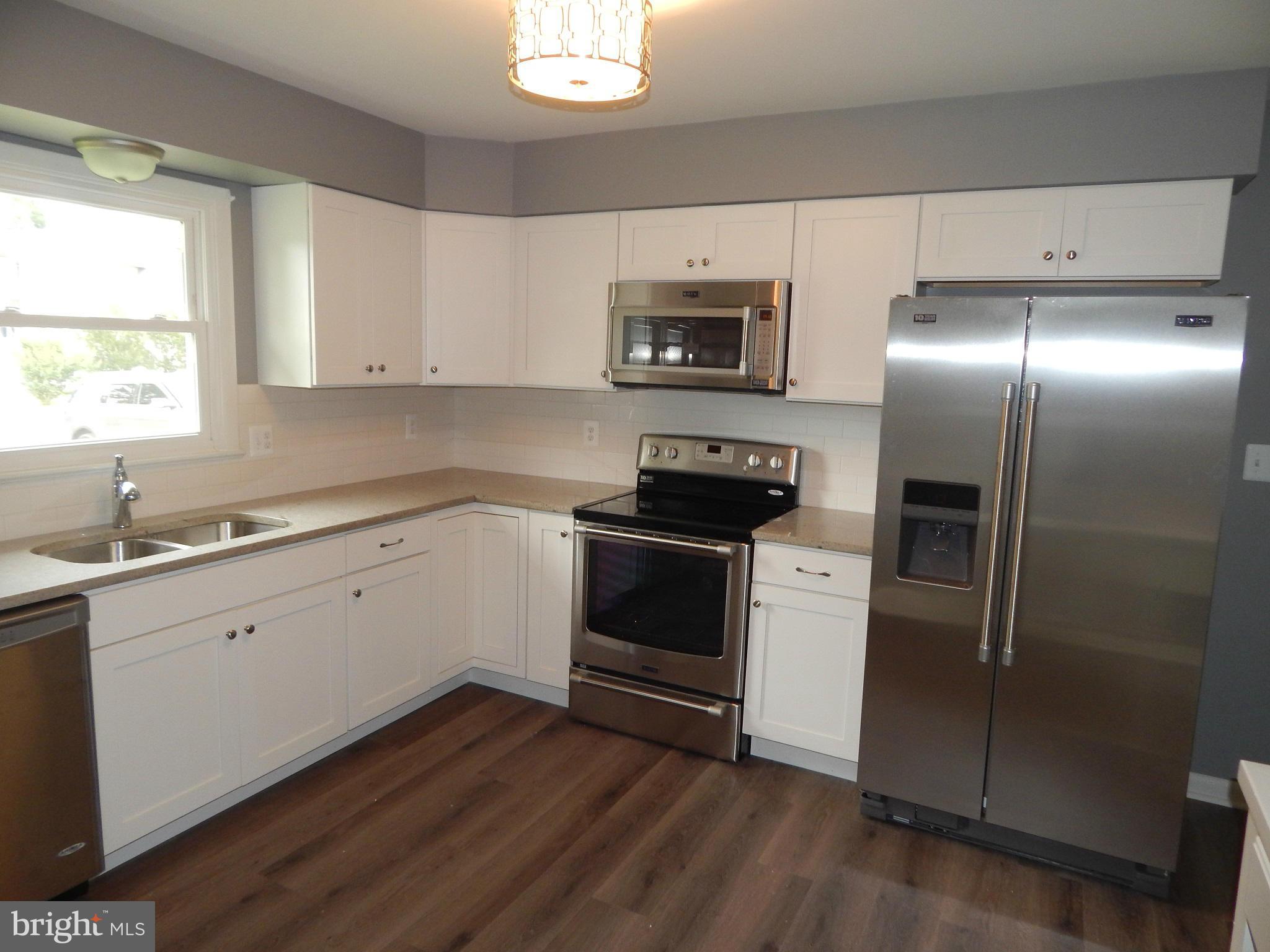 111 Calvert Towne Road Prince Frederick, MD 20678 - Photo 3 of 26 a kitchen with a refrigerator stove and sink