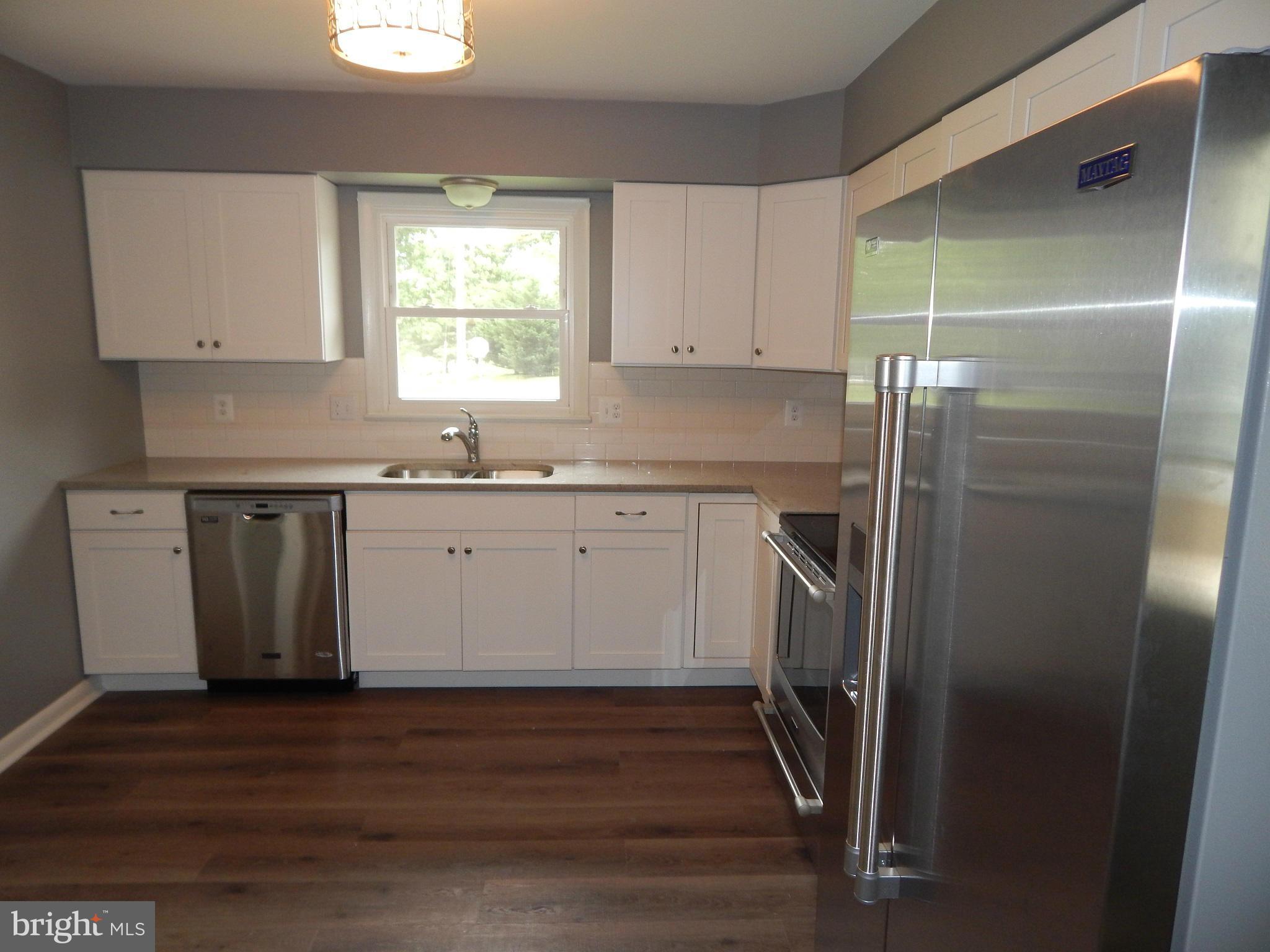 111 Calvert Towne Road Prince Frederick, MD 20678 - Photo 4 of 26 a kitchen with a sink a window and stainless steel appliances