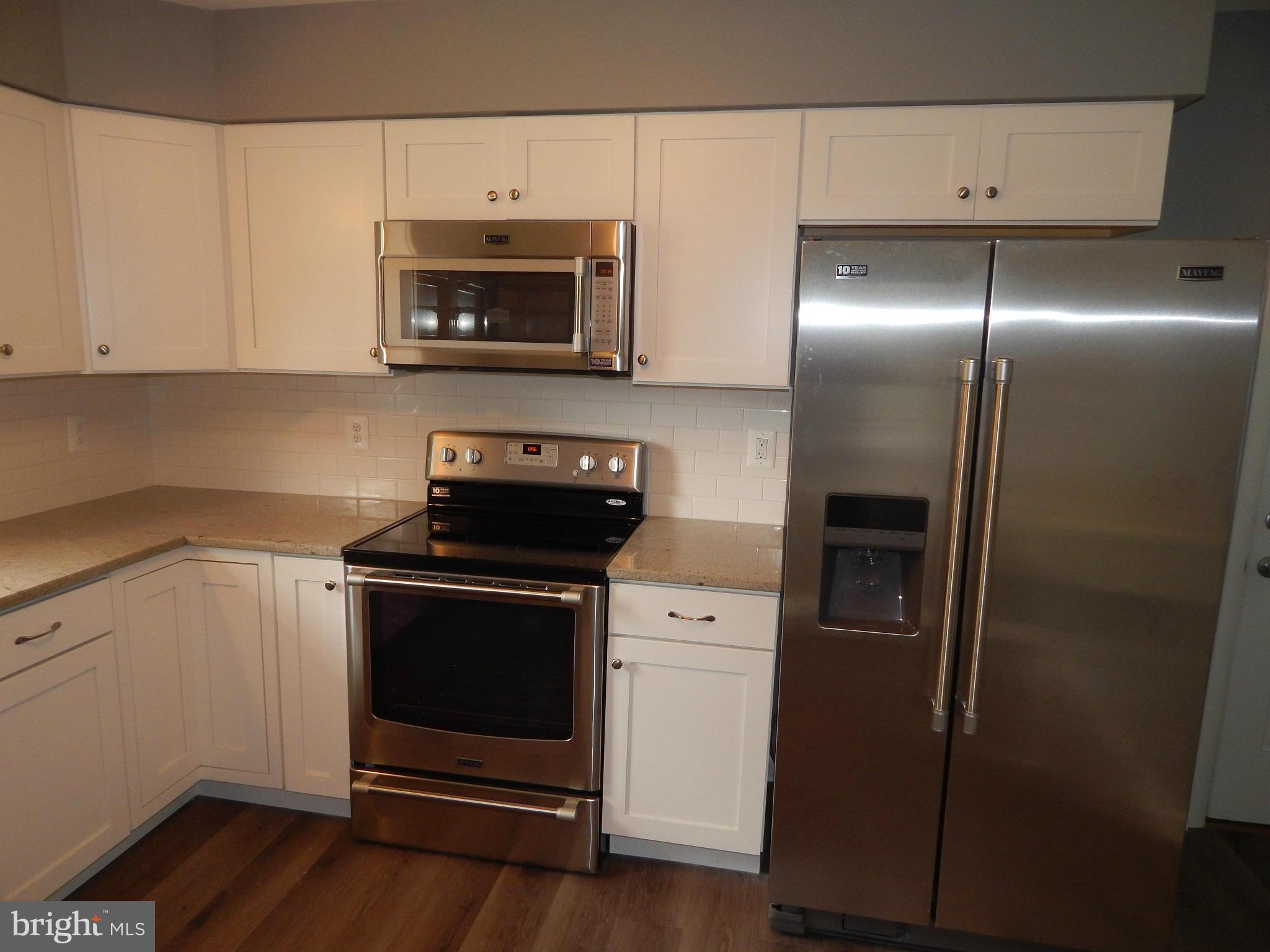 111 Calvert Towne Road Prince Frederick, MD 20678 - Photo 6 of 26 a kitchen with a stove and a microwave