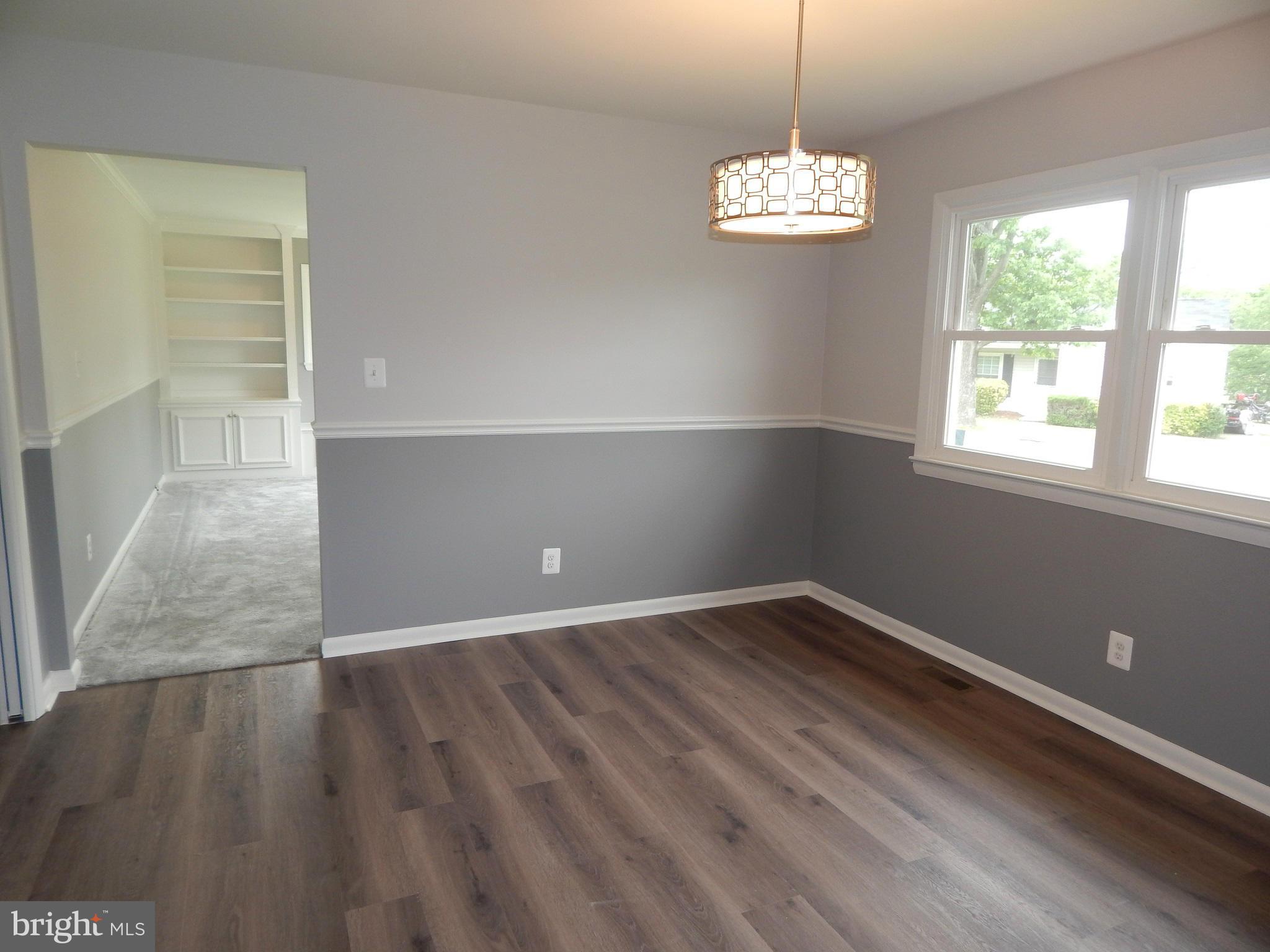 111 Calvert Towne Road Prince Frederick, MD 20678 - Photo 8 of 26 an empty room with wooden floor and windows