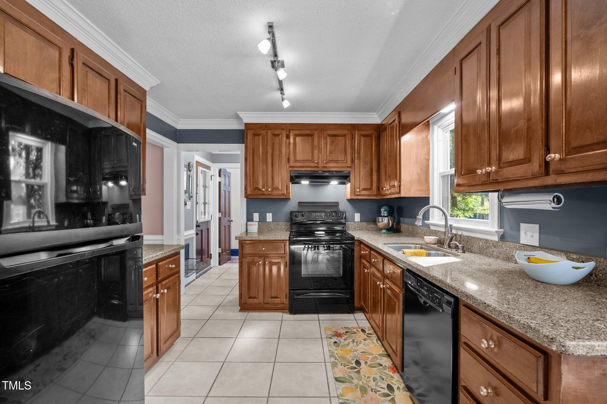 2916 Bolo Trail Raleigh, NC 27615 - Photo 11 of 43 a kitchen with stainless steel appliances granite countertop a stove sink refrigerator and cabinets