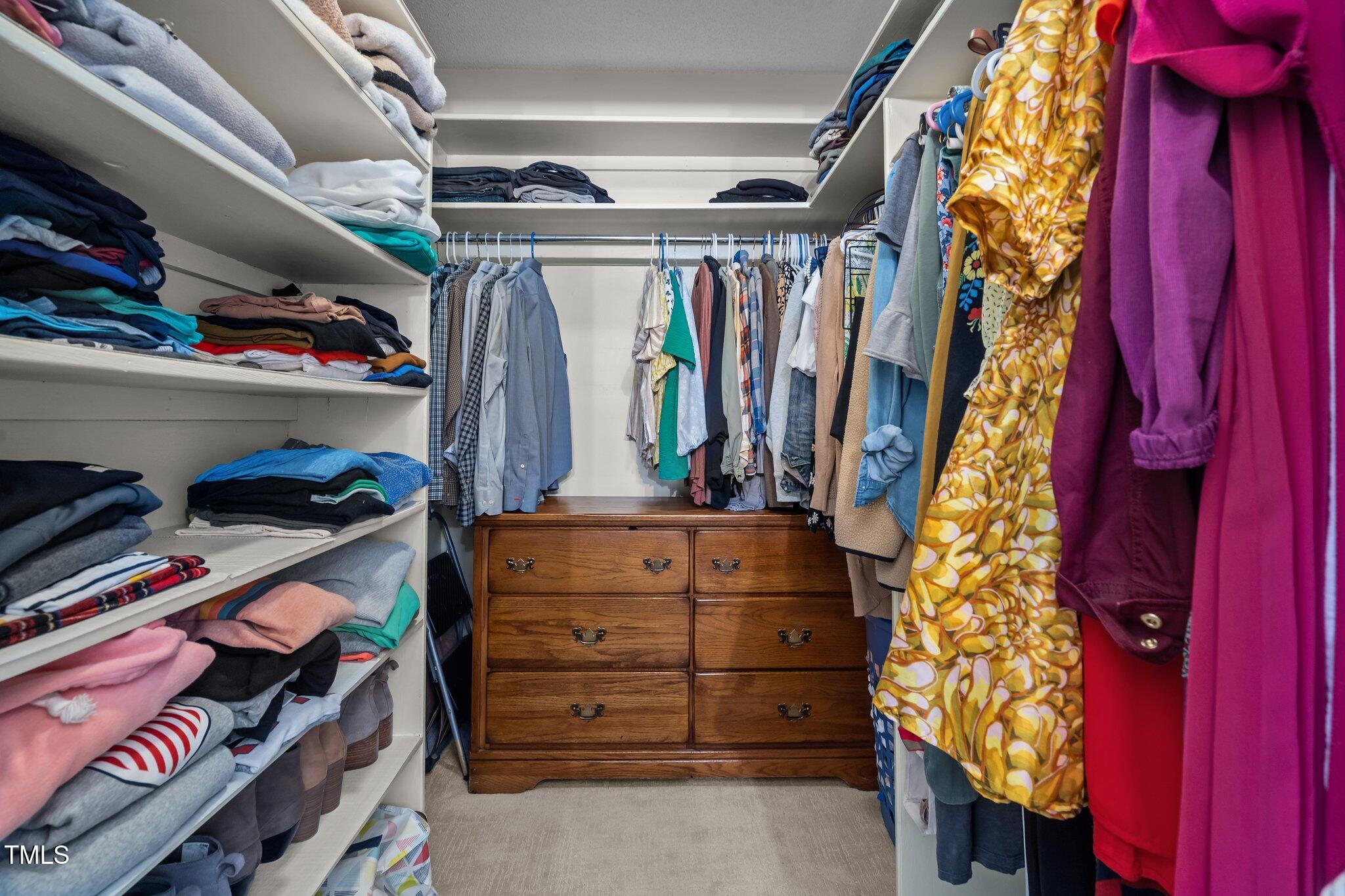 2916 Bolo Trail Raleigh, NC 27615 - Photo 24 of 43 a view of walk in closet with clothes and shoes
