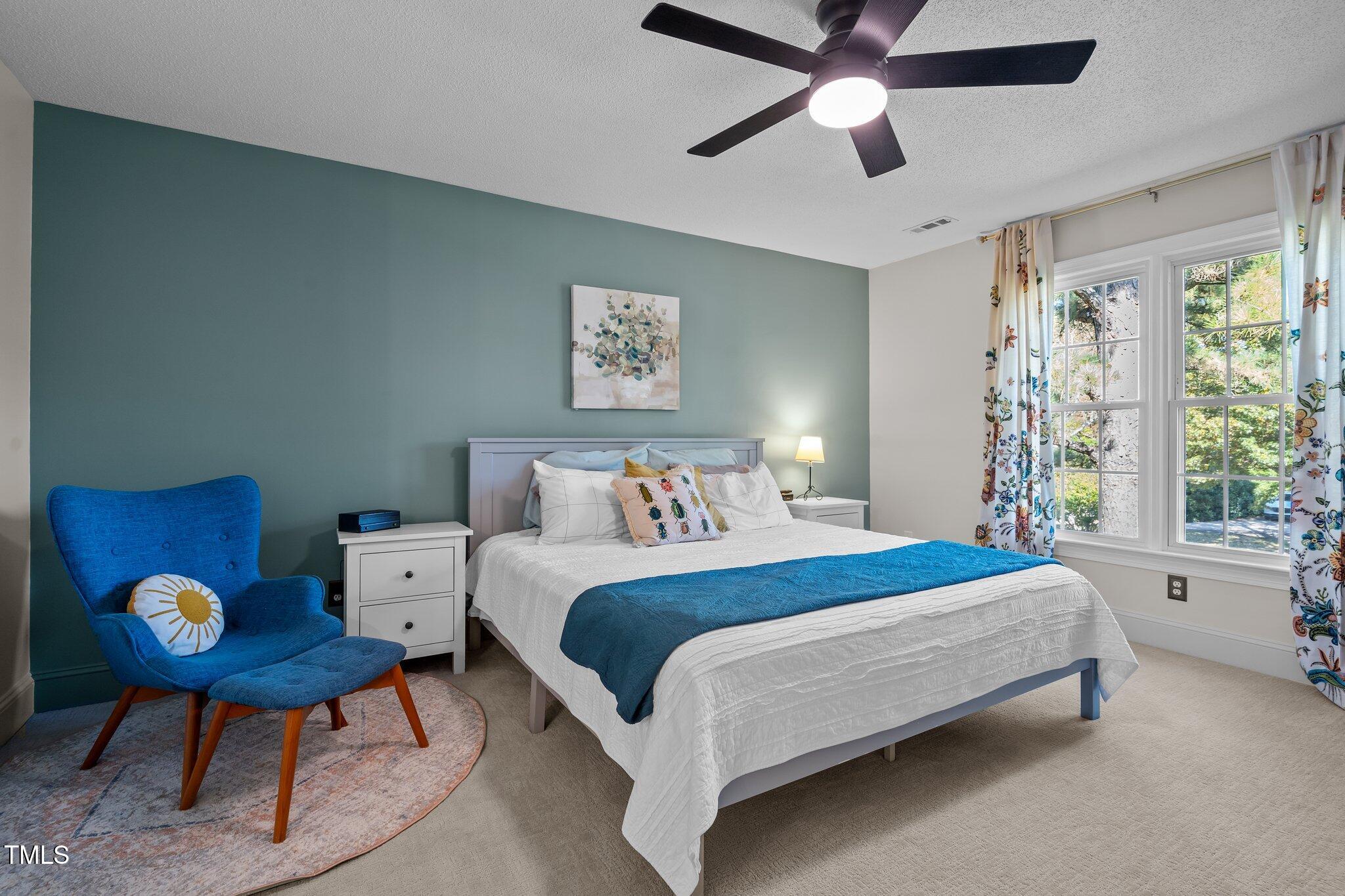 2916 Bolo Trail Raleigh, NC 27615 - Photo 26 of 43 a bedroom with bed and a chandelier