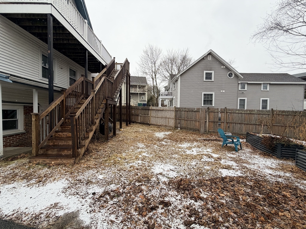 341 Linwood Avenue, Unit 2 Newton, MA 02460 - Photo 15 of 18 a view of a house with a yard and wooden fence