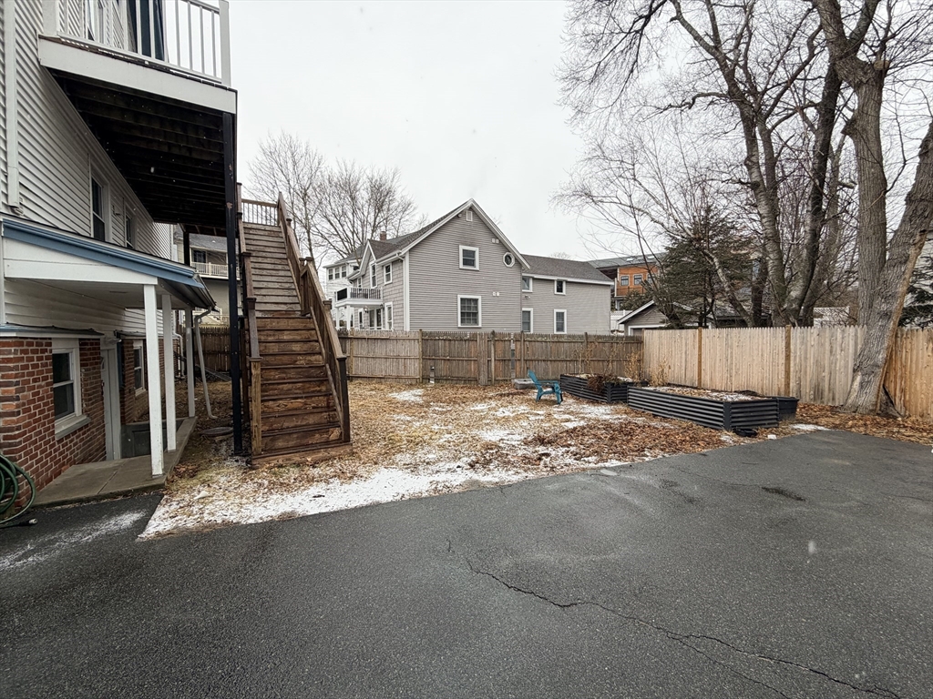 341 Linwood Avenue, Unit 2 Newton, MA 02460 - Photo 16 of 18 a view of a house with a yard covered in snow