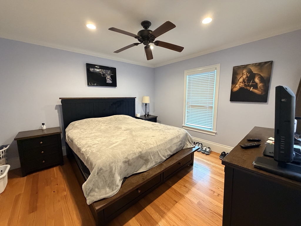341 Linwood Avenue, Unit 2 Newton, MA 02460 - Photo 5 of 18 a bedroom with a bed and a flat screen tv