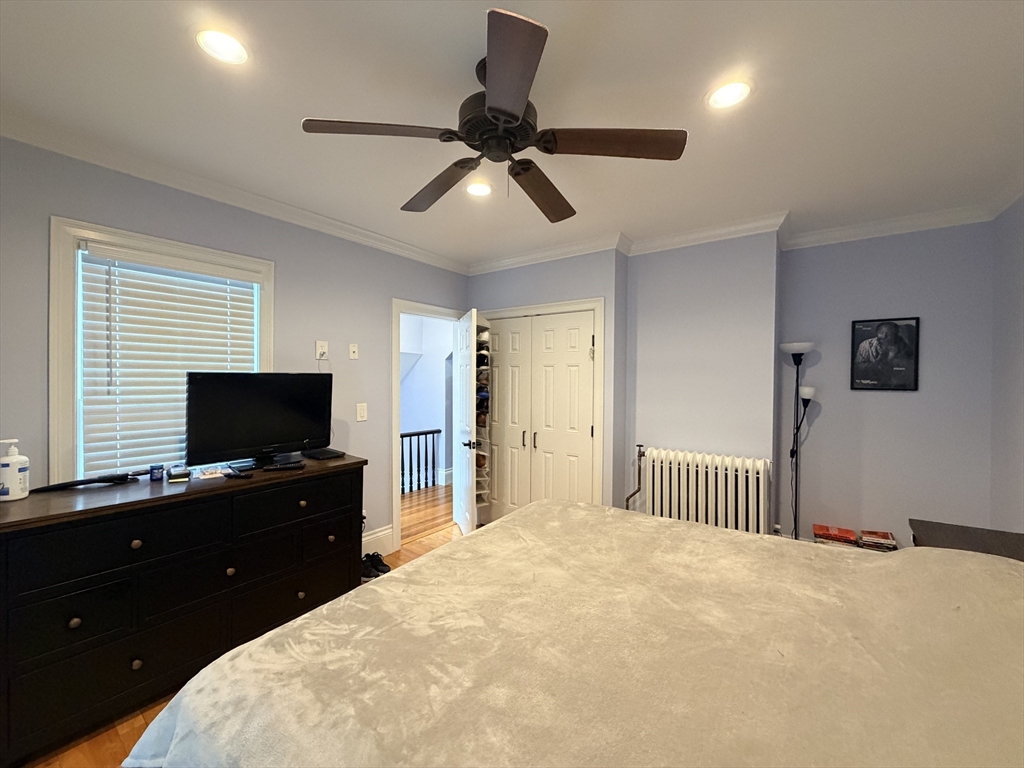 341 Linwood Avenue, Unit 2 Newton, MA 02460 - Photo 6 of 18 a bedroom with a bed and a flat screen tv