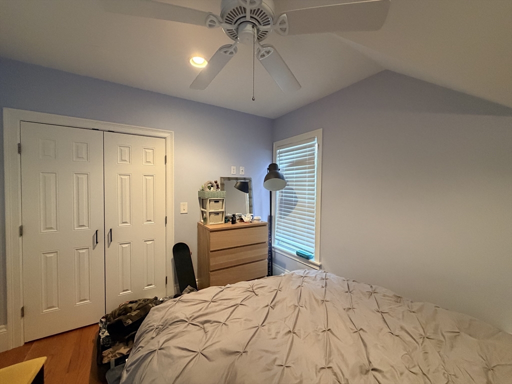 341 Linwood Avenue, Unit 2 Newton, MA 02460 - Photo 8 of 18 a bedroom with a bed and a chandelier