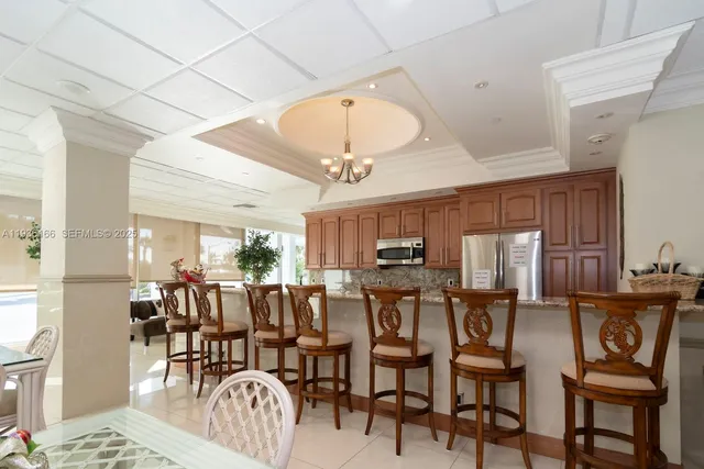 a room with lots of furniture and a view of dining room