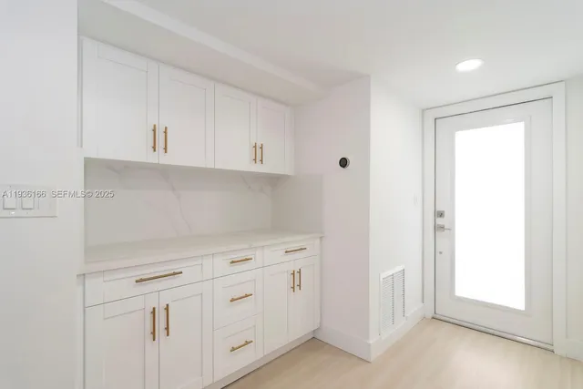 a view of a kitchen with wooden floor