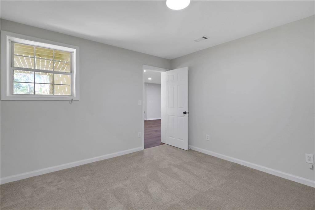 6259 Spring Lake Drive Flowery Branch, GA 30542 - Photo 18 of 35 an empty room with a natural light