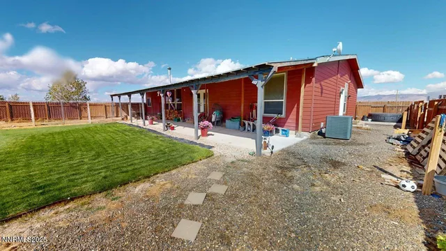 a bedroom with furniture and a large window