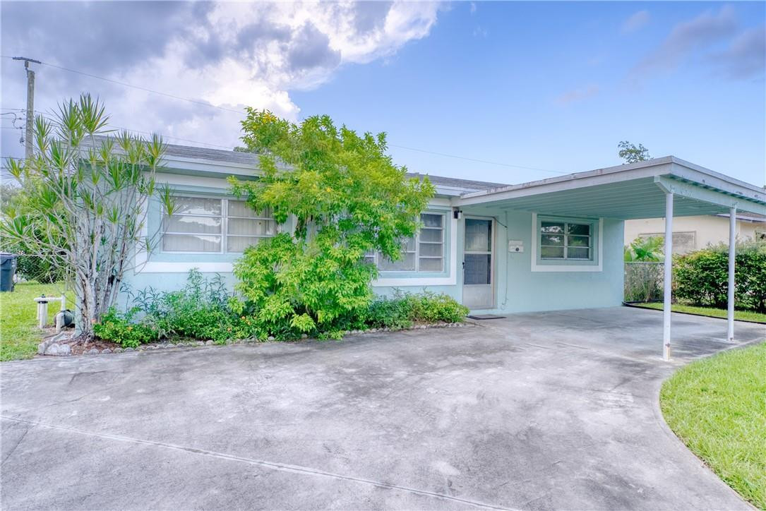 6443 Perry Street Hollywood, FL 33024 - Photo 1 of 1 a view of a house with a yard and potted plants