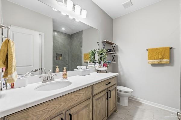 14126 Wichita Falls Lane McAllen, TX 78504 - Photo 10 of 14 a bathroom with a granite countertop toilet sink and mirror