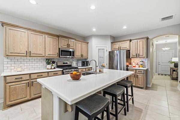 14126 Wichita Falls Lane McAllen, TX 78504 - Photo 2 of 14 a kitchen with a sink a stove a refrigerator cabinets and a dining table