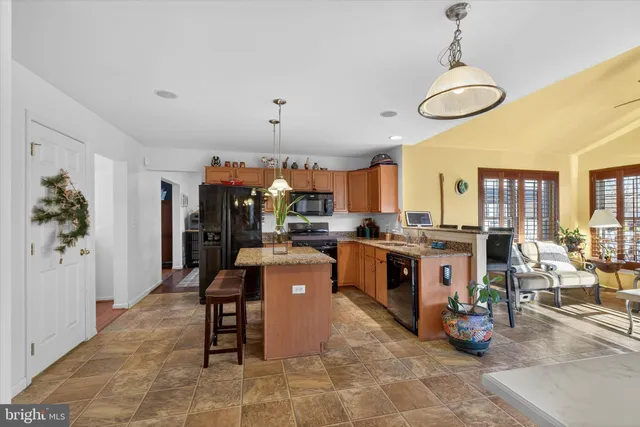 a large room with lots of table chair and a potted plant