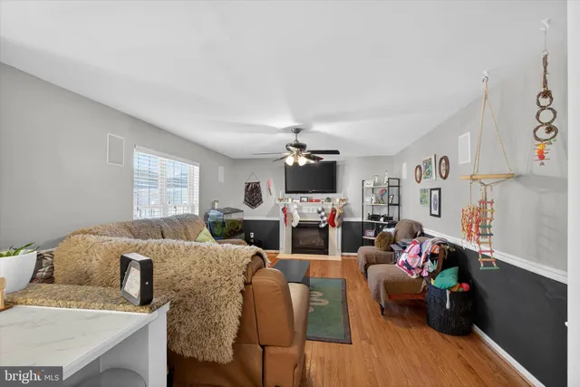 a living room with furniture a flat screen tv and a window
