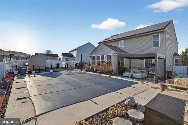 a view of a house with a backyard and porch