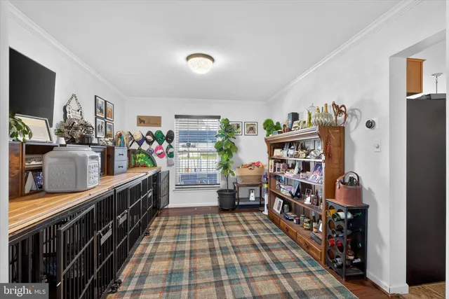 a room with lots of wooden furniture and a book shelf