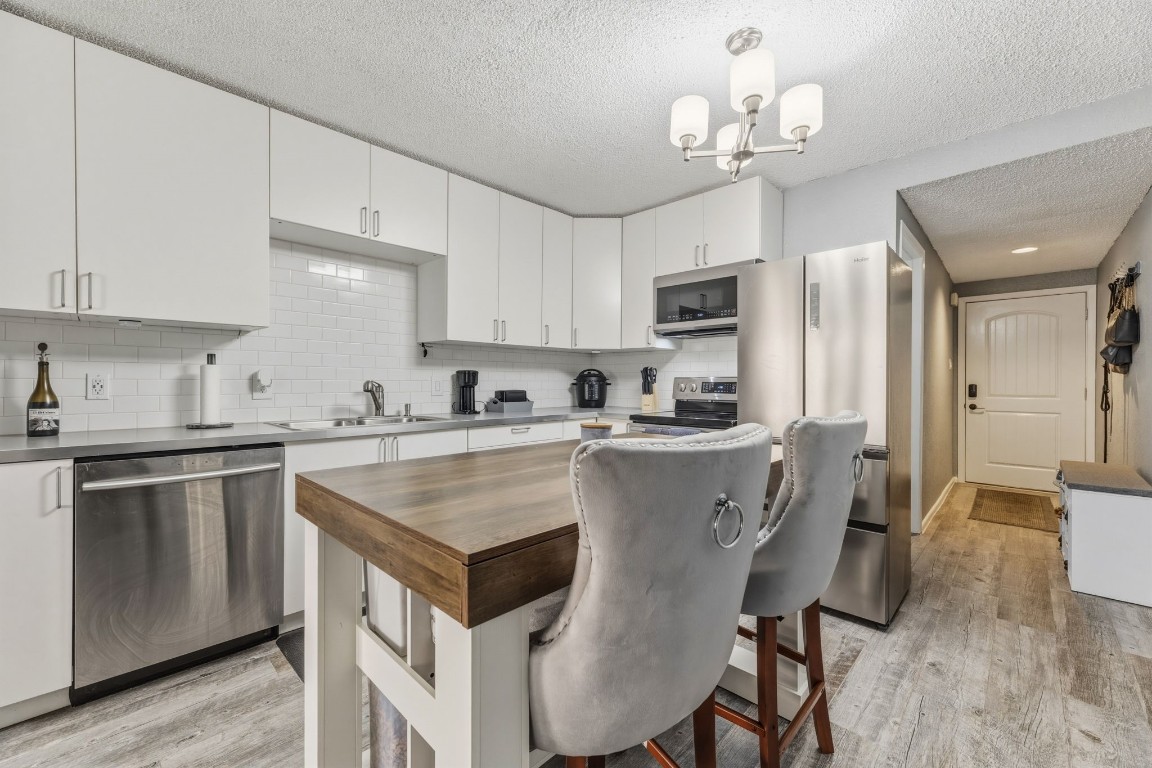 12900 Walden Road, Unit 312C Montgomery, TX 77356 - Photo 9 of 26 Renovated kitchen with stainless appliances and new refrigerator